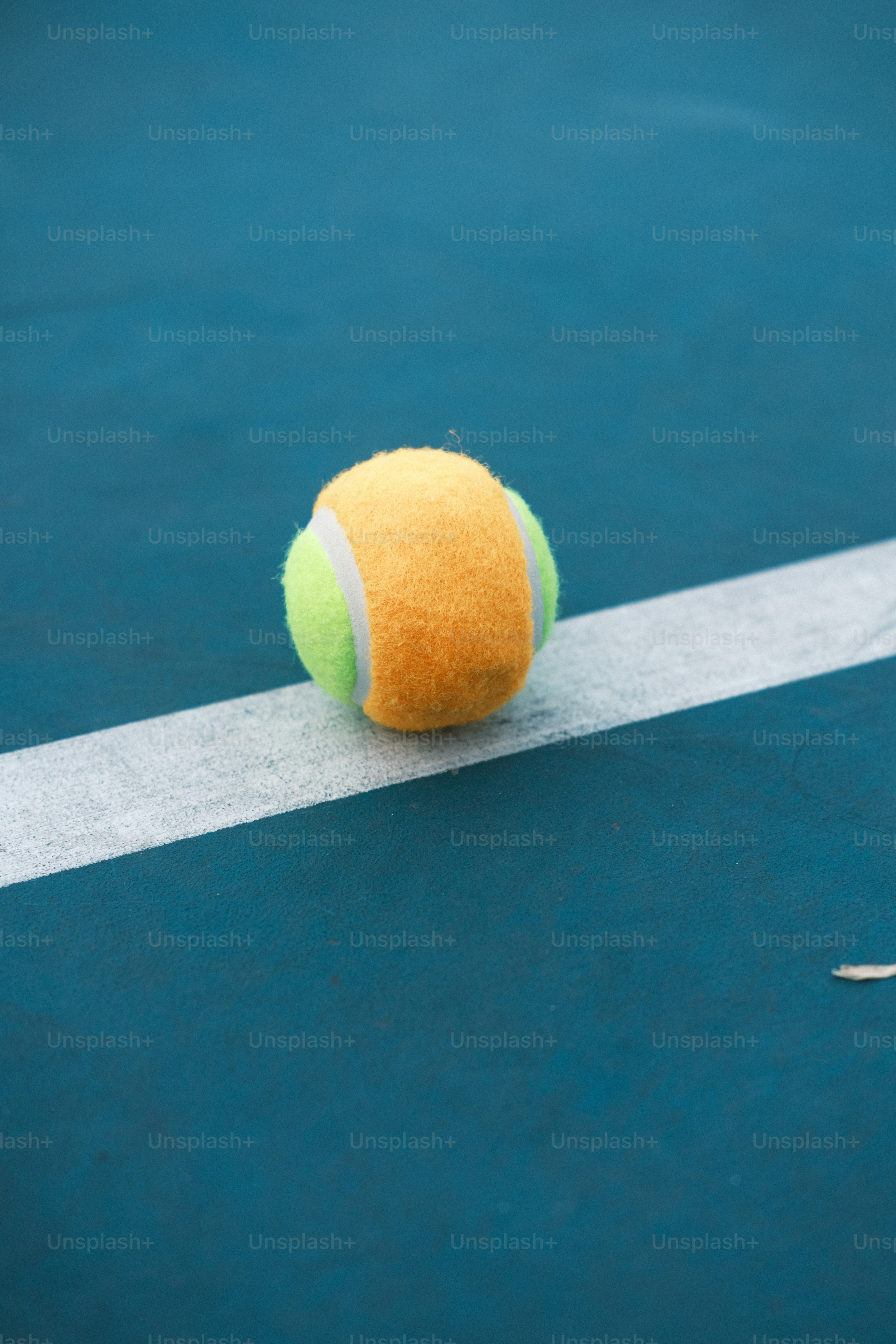 a tennis ball sitting on a tennis court