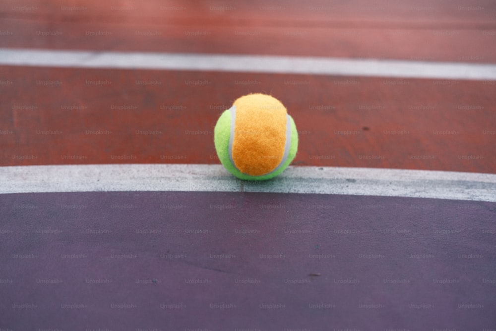 a tennis ball sitting on a tennis court