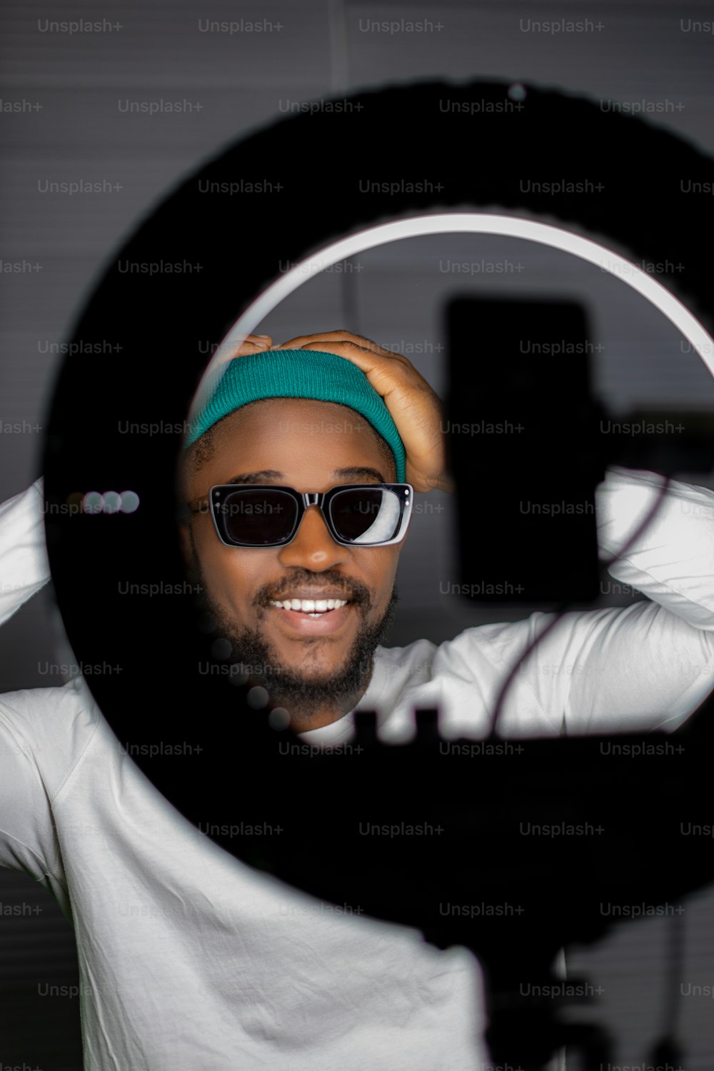 a man wearing sunglasses and a green hat