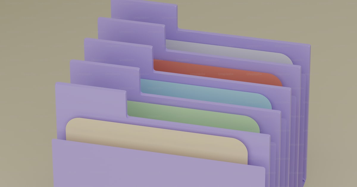A pile of folders stacked on top of each other photo – Folder Image on ...