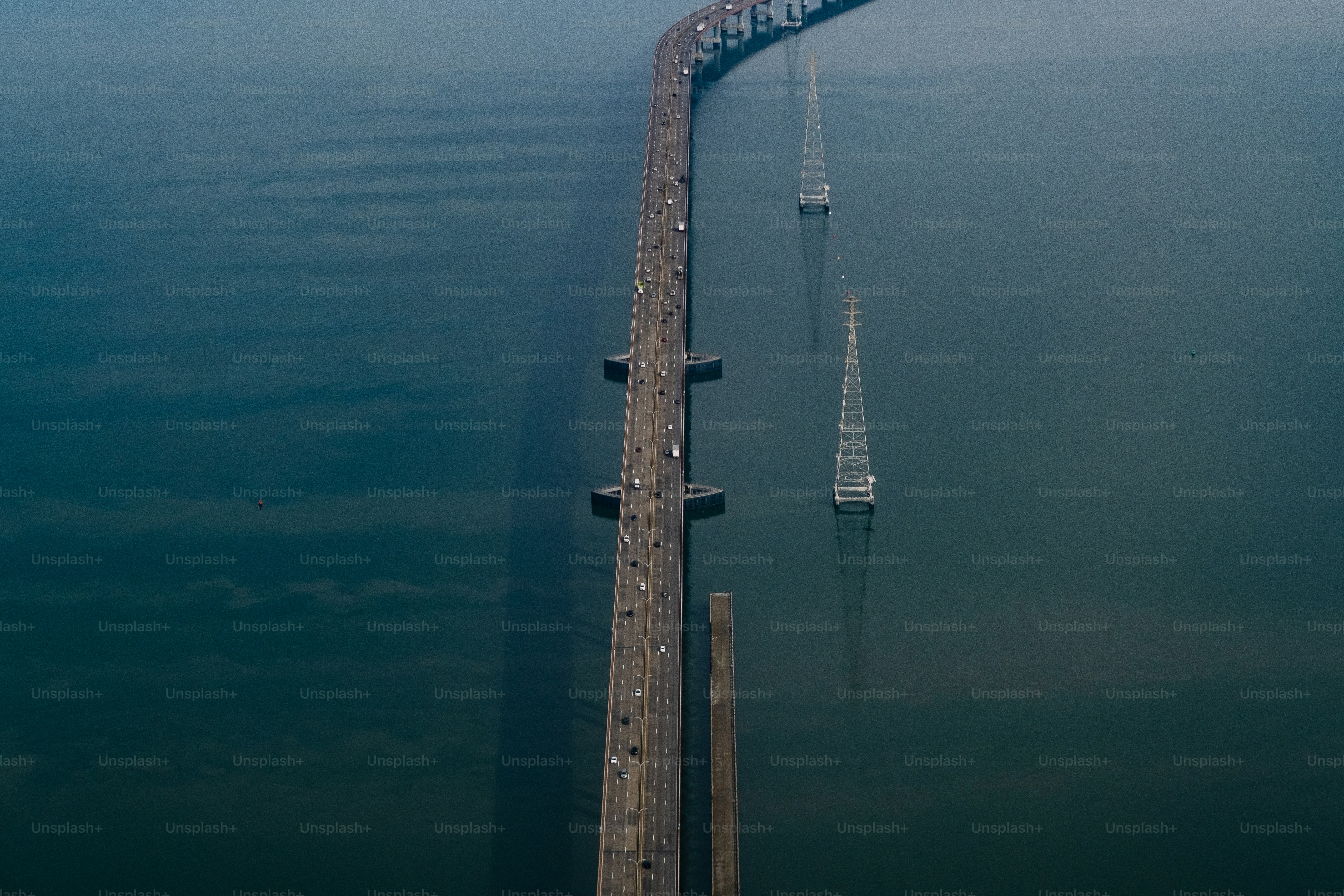 An aerial view of a long bridge over water photo Bridge Image on Unsplash