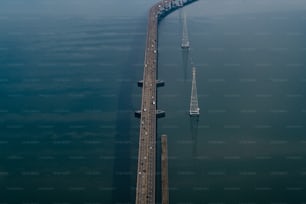 an aerial view of a long bridge over water