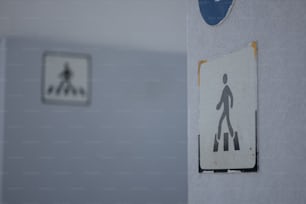 a bathroom with a sign on the wall