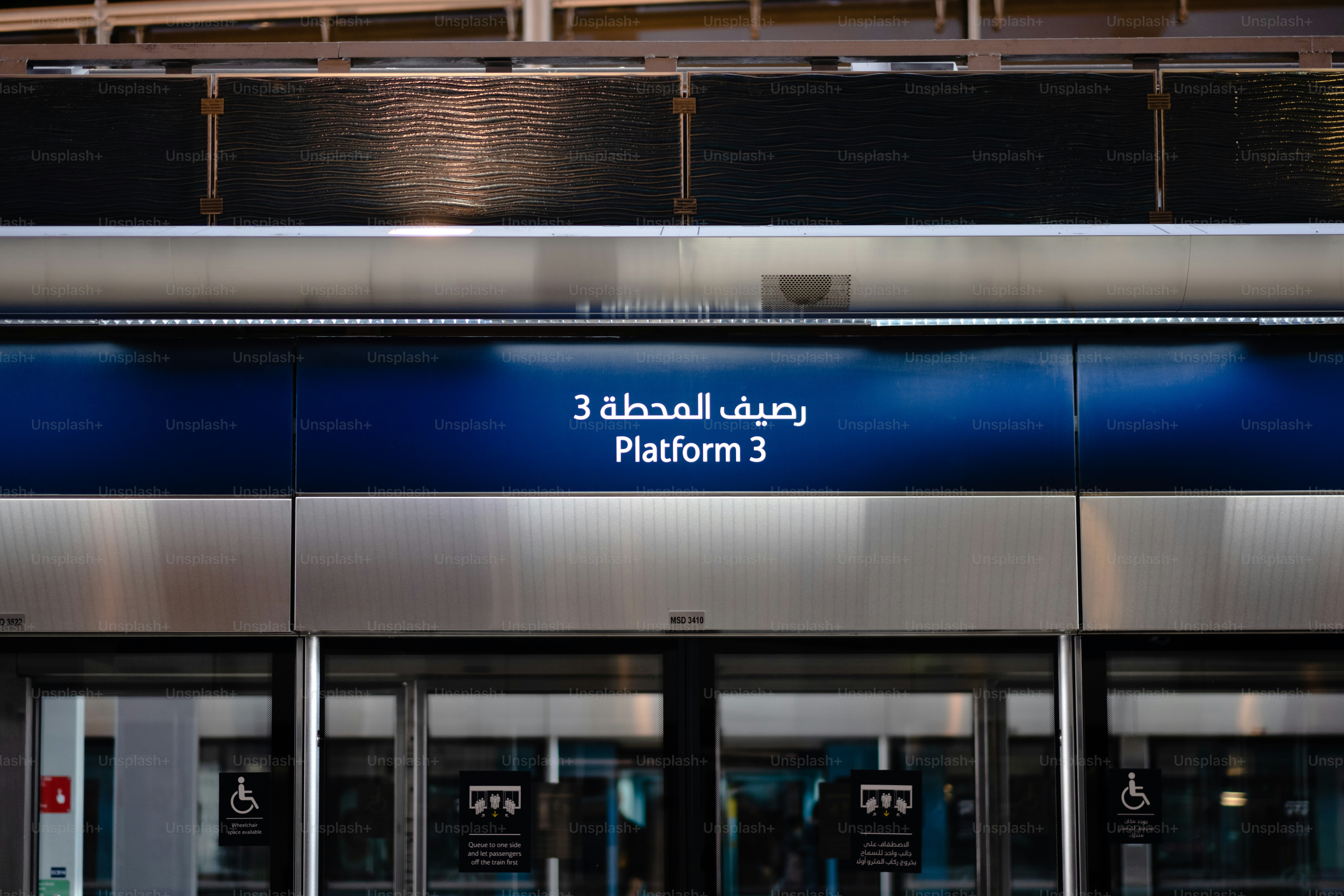 the entrance to a building with a blue sign above it