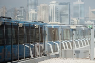 a train traveling past a tall city skyline