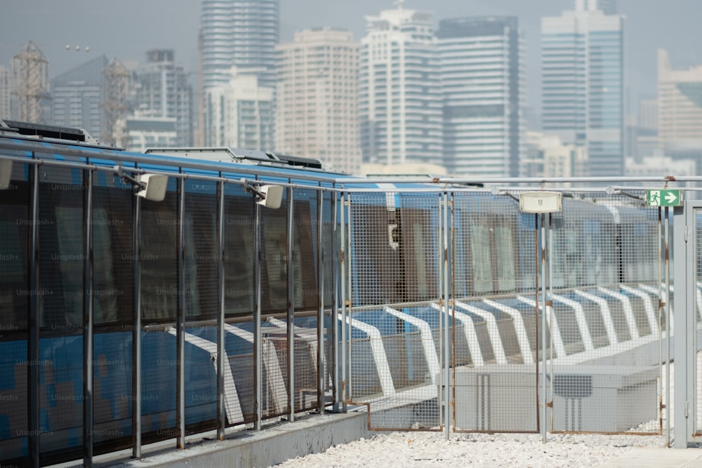 a train traveling past a tall city skyline