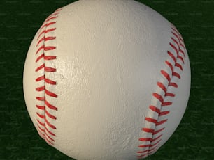 a close up of a baseball on a green field