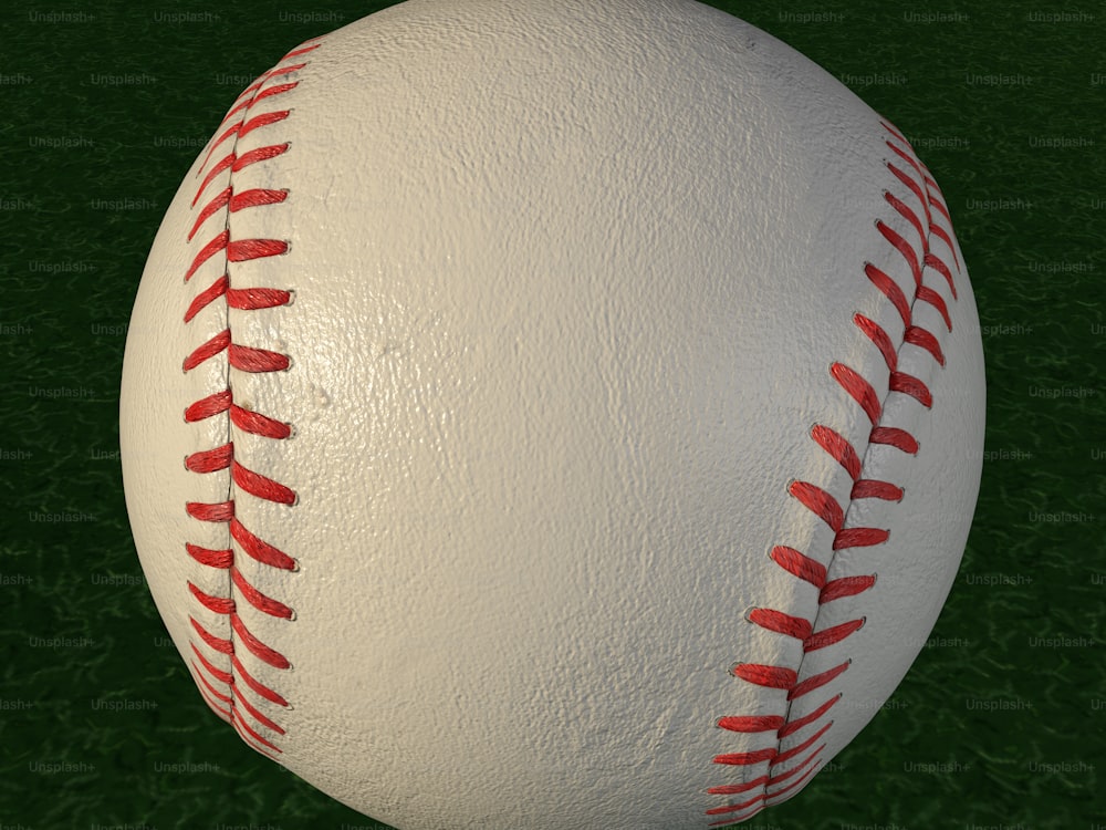 a close up of a baseball on a green field