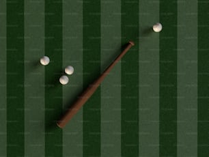a baseball bat and three balls on a field