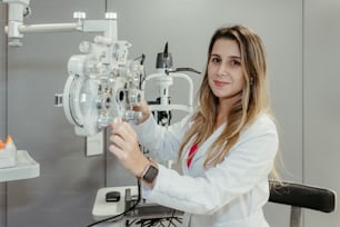 a woman in a white lab coat working on a machine