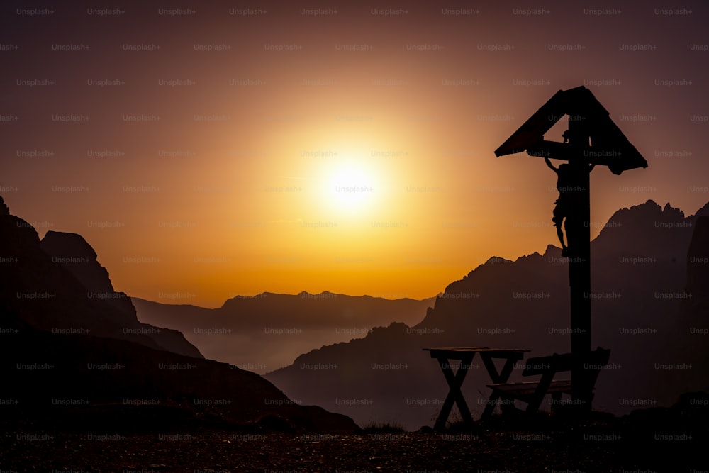 the sun is setting over a mountain range