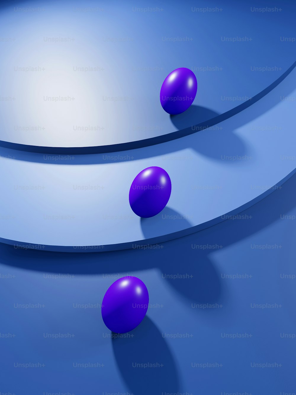 three purple balls are on a blue surface