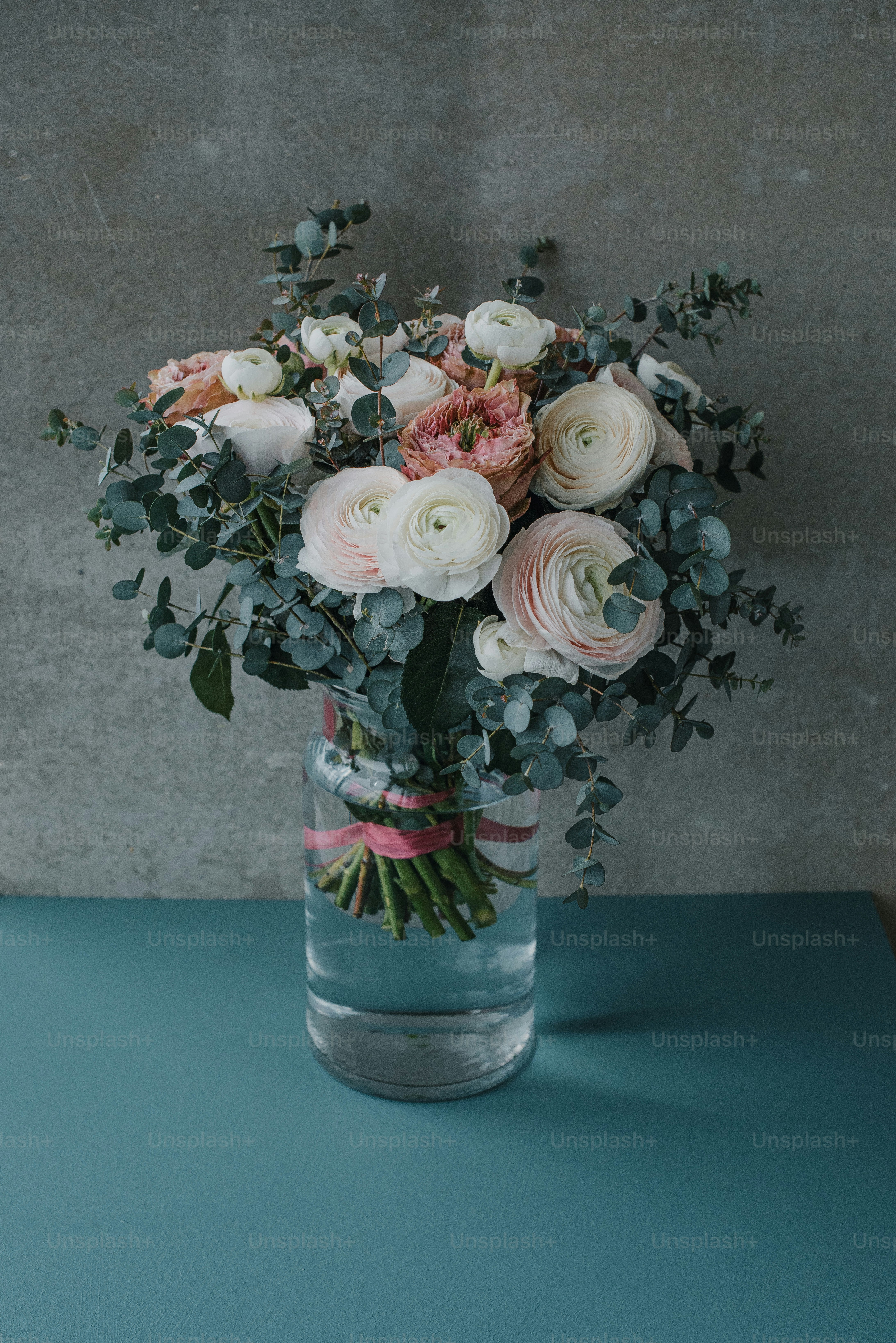 A vase filled with lots of flowers on top of a table photo – Floral ...