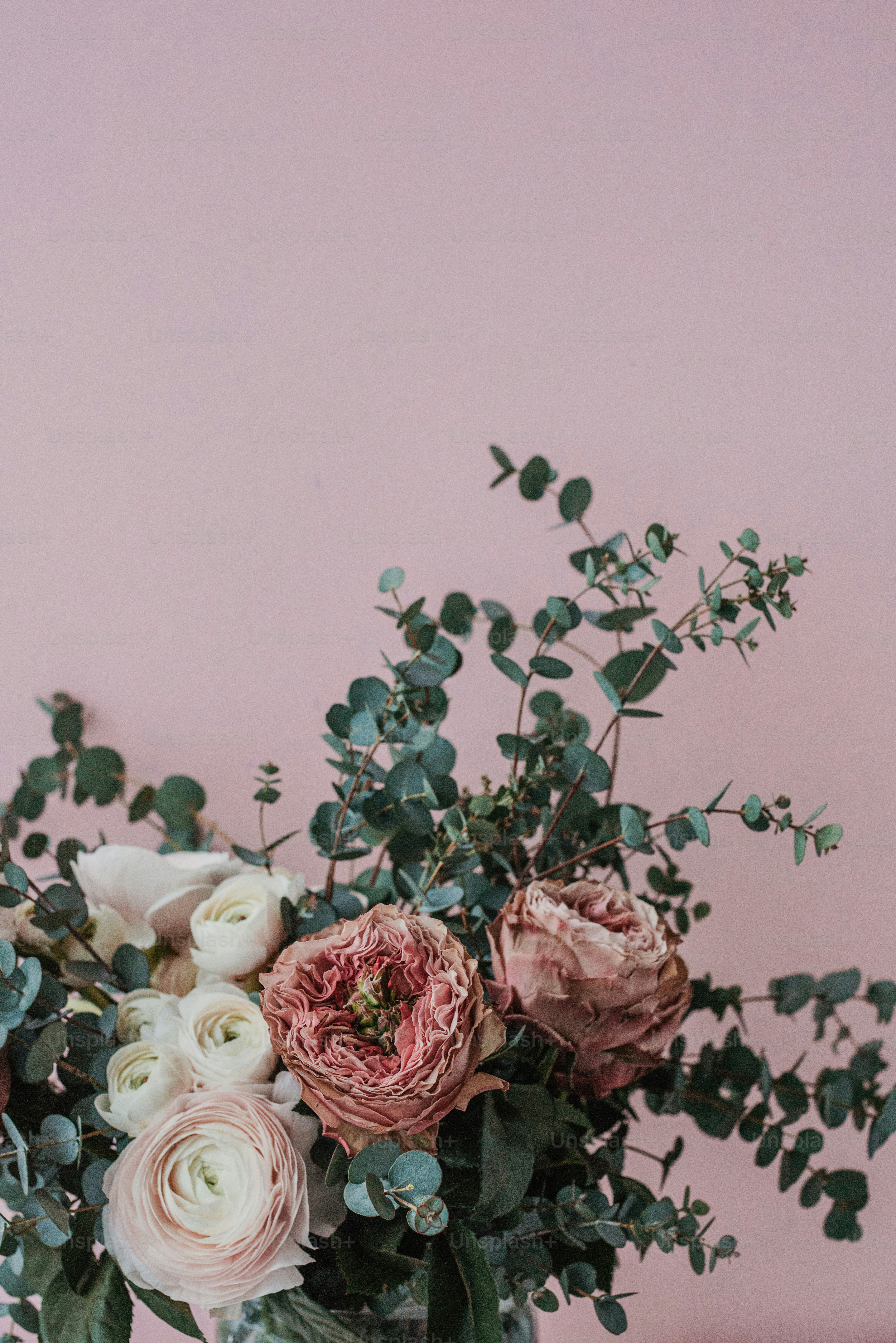 a vase filled with lots of flowers on top of a table