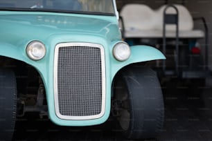 a close up of the front end of a green vehicle