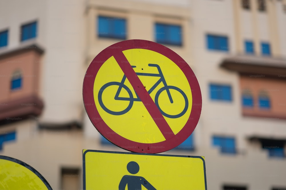 a yellow and red sign that says no bicycles