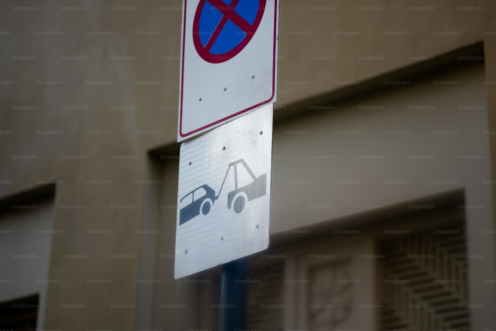 a no parking sign on a pole next to a building