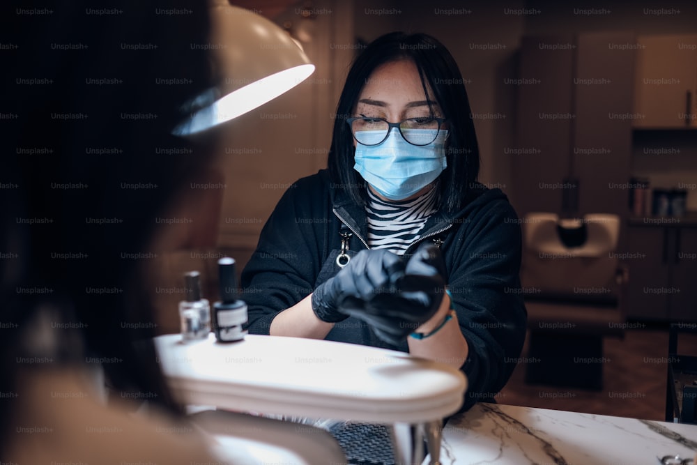 a woman wearing a face mask and gloves