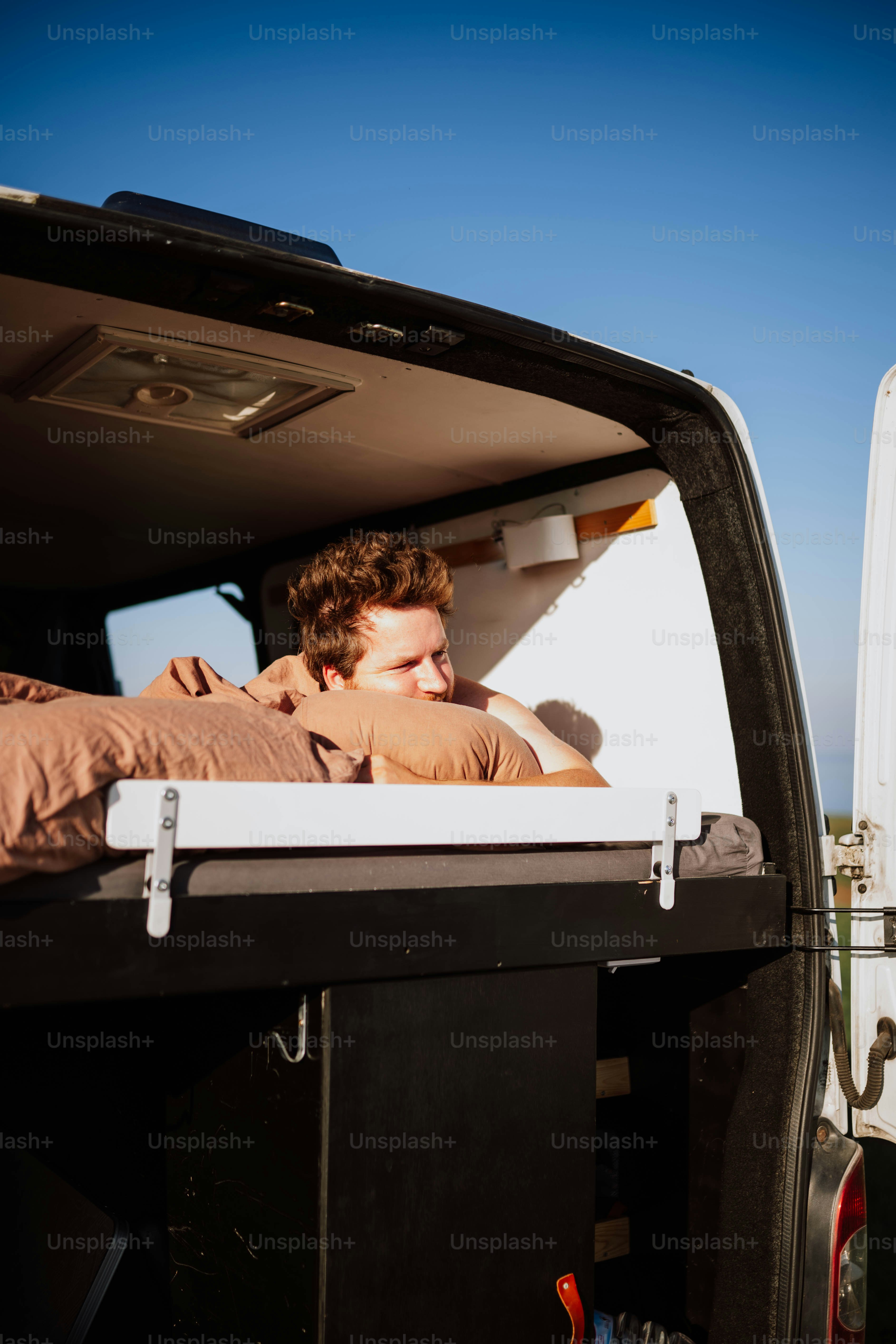 A man laying in the back of a truck photo – Rv camping Image on Unsplash