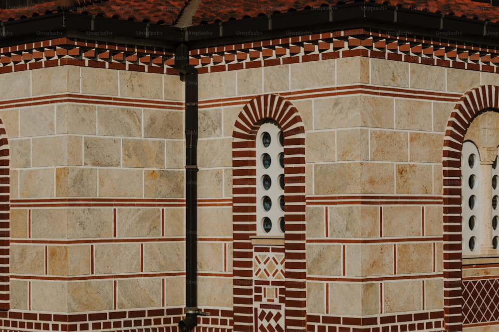 a clock on the side of a brick building