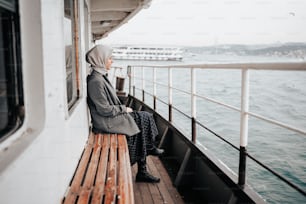 a woman sitting on a bench on a boat