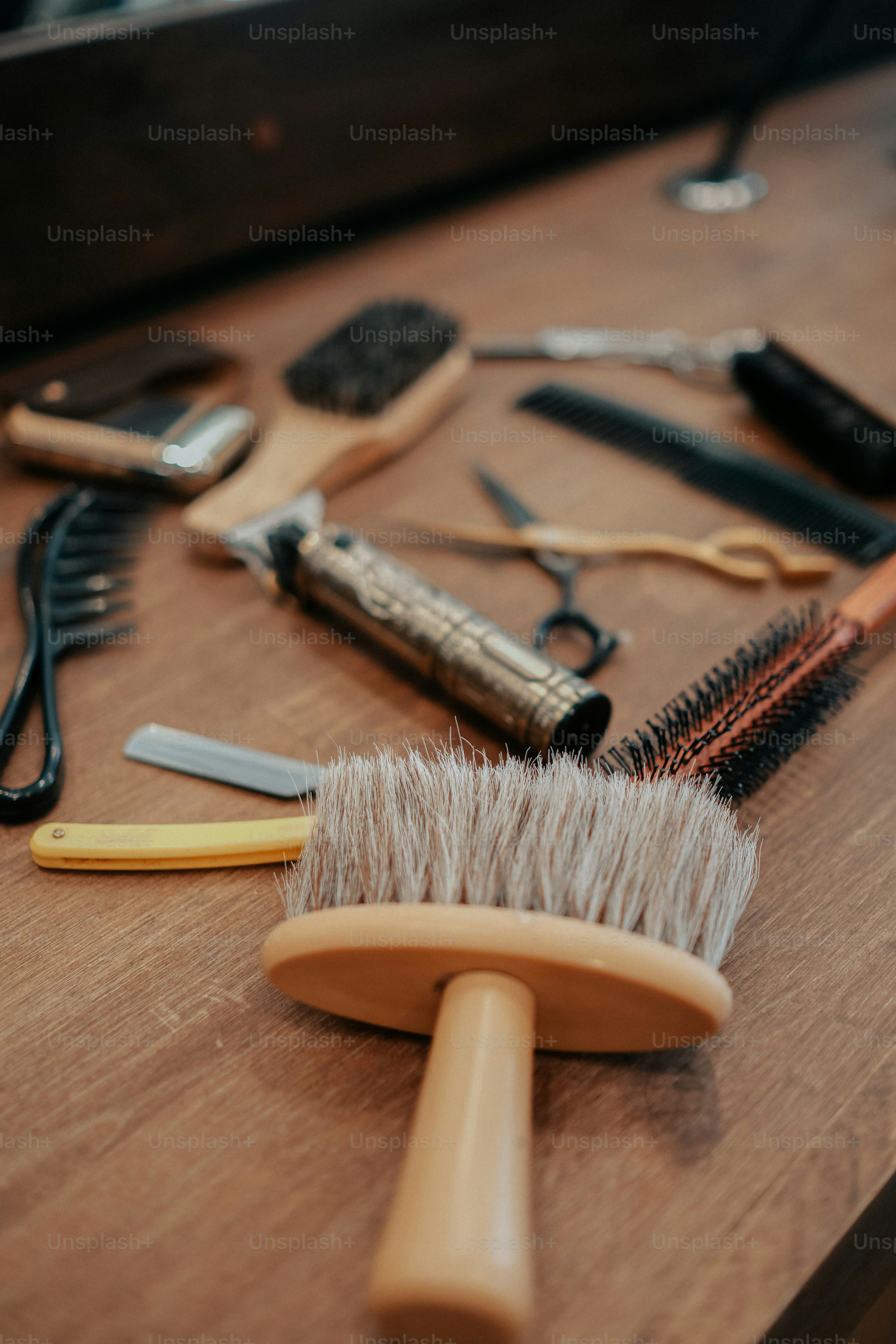 a wooden table topped with different types of hair brushes
