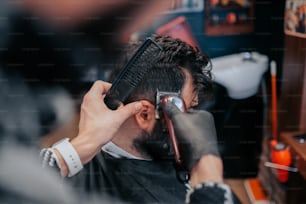 a man getting his hair cut at a barber shop