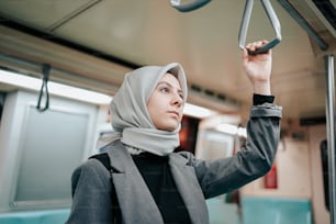 a woman in a hijab on a train
