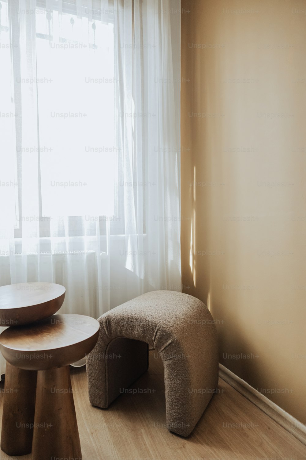 a living room with a table and two stools