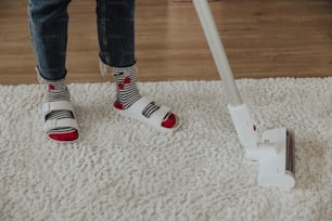 a person standing on a carpet with a mop