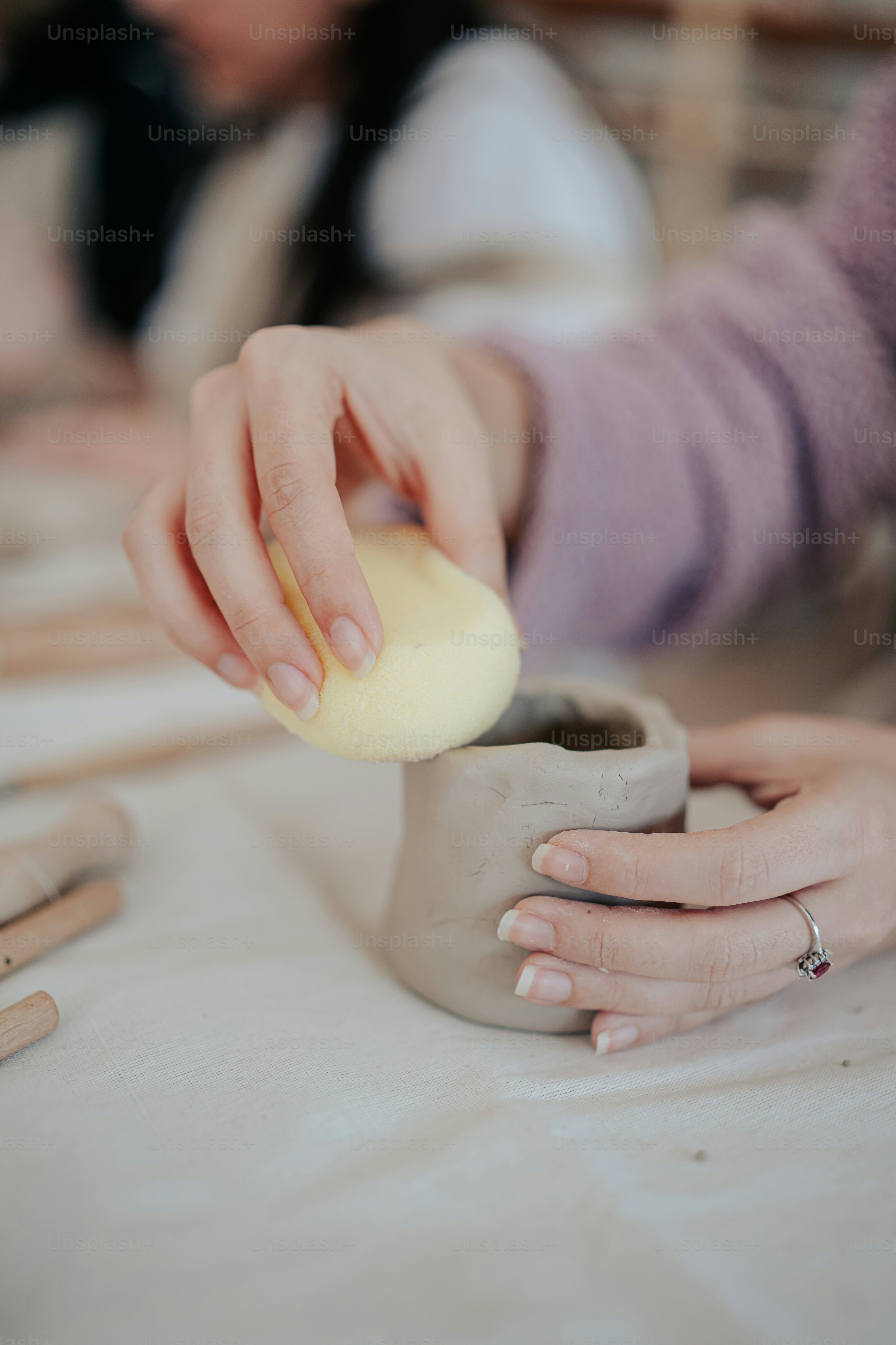 a close up of a person pouring something into a cup
