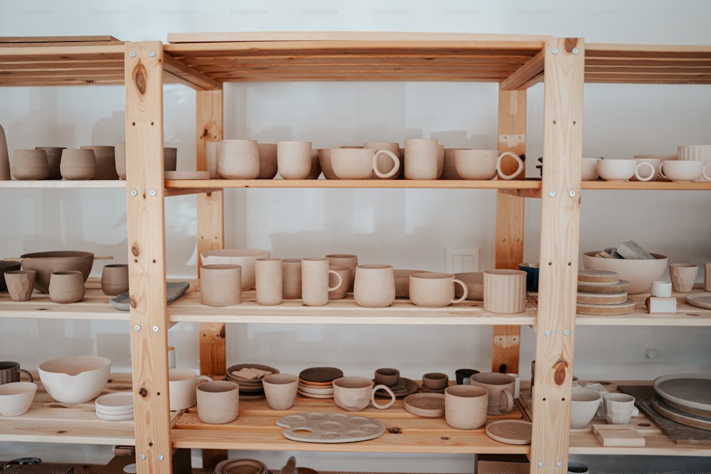 a shelf filled with lots of cups and bowls