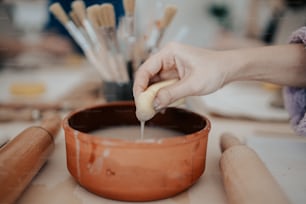 a person is dipping something into a bowl