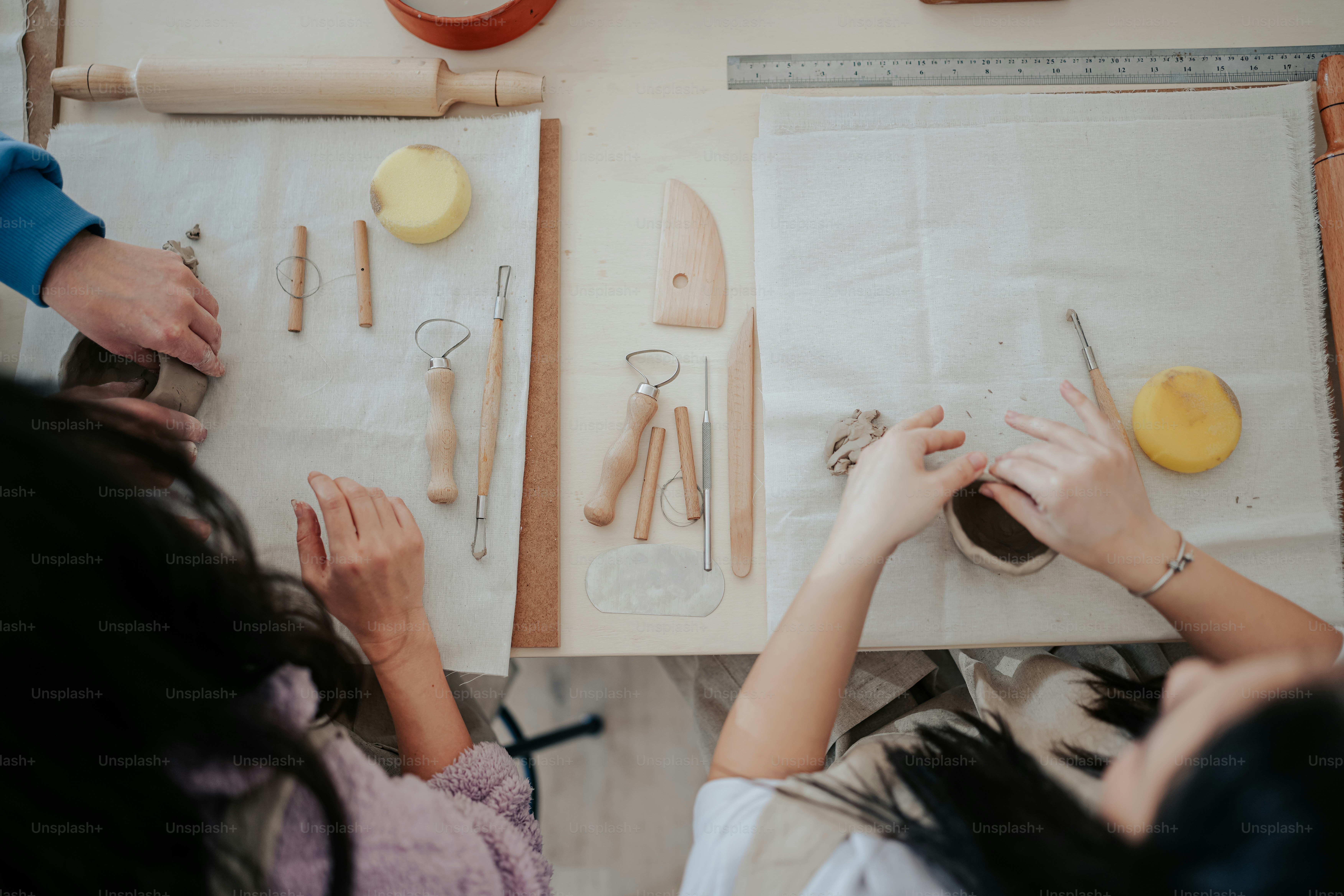 a group of people working on crafts on a table