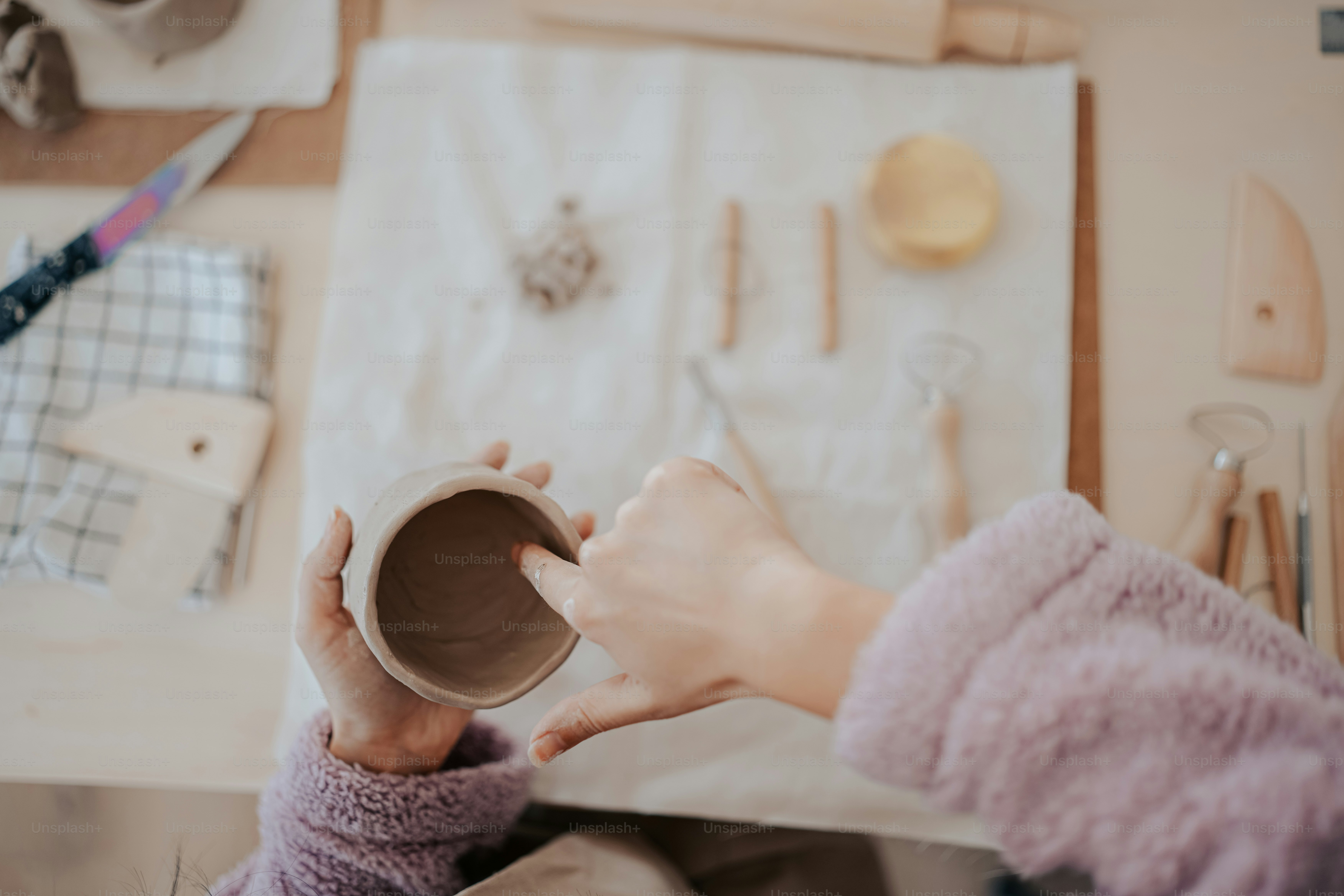a woman is holding a cup in her hands