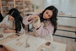 two women working on pottery in a pottery studio