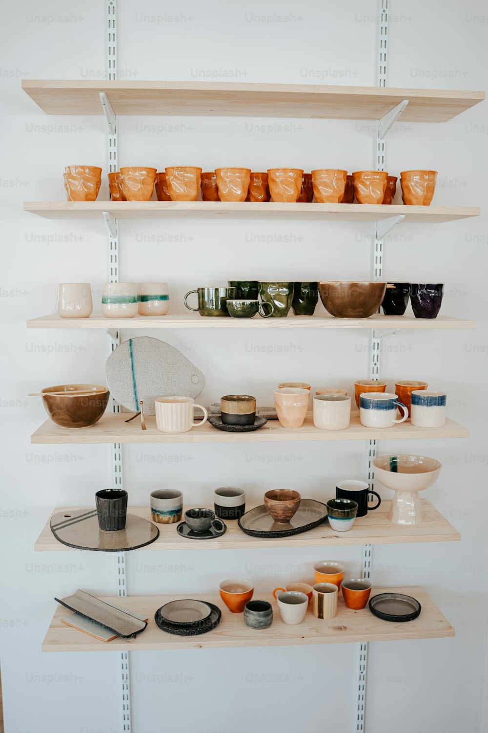 a shelf filled with lots of cups and bowls