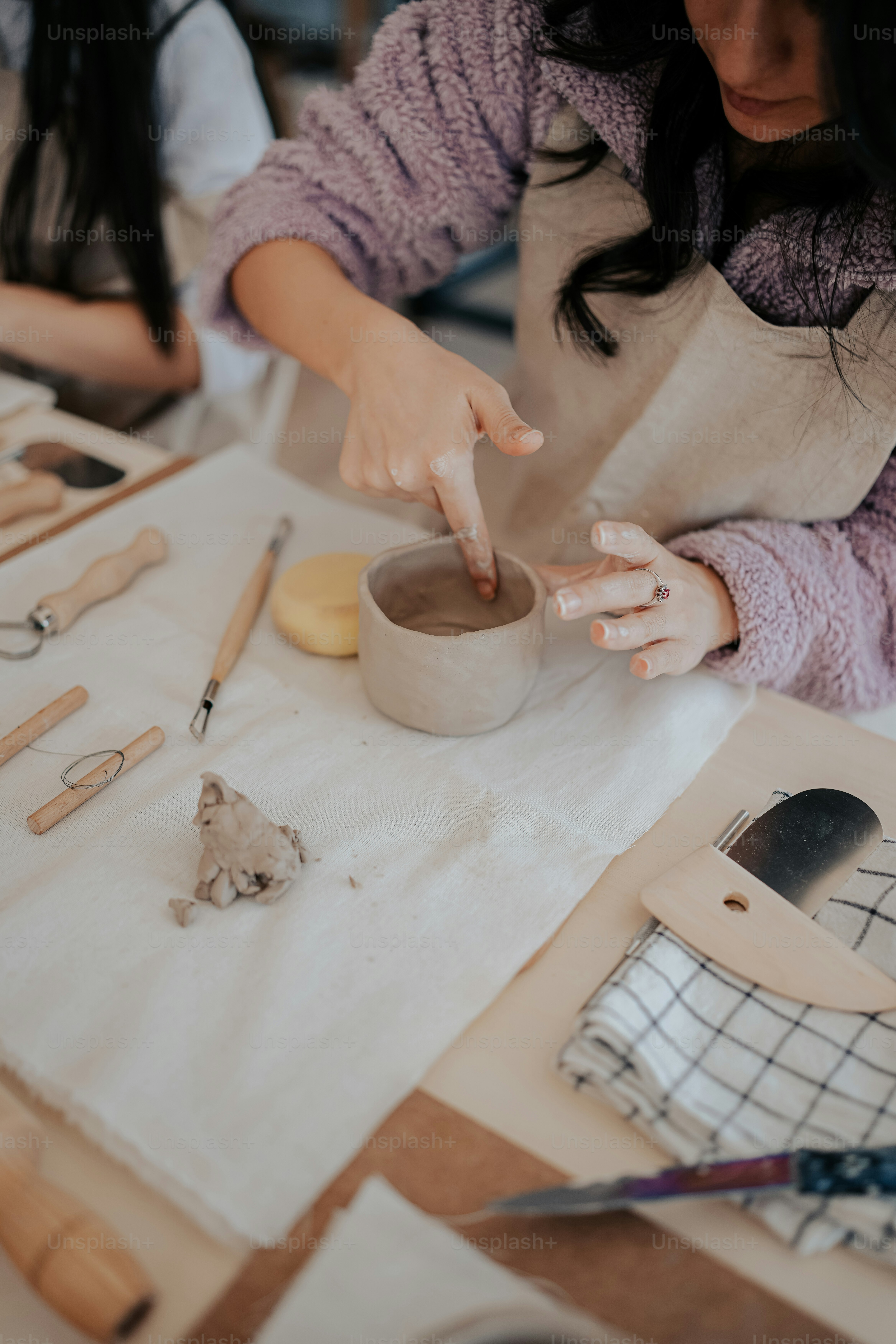 a woman is making a bowl on a table