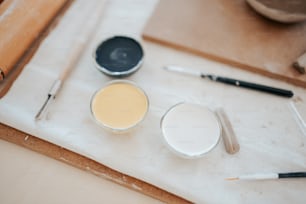 a table topped with different types of paint