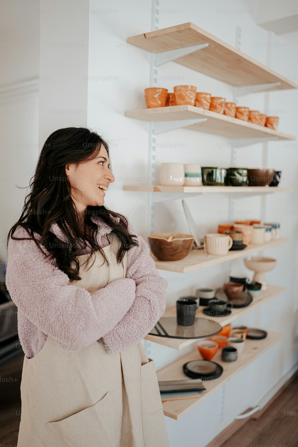 a woman standing in front of a shelf of food