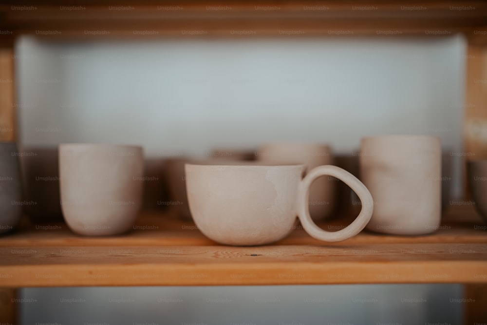 a close up of a shelf with cups on it