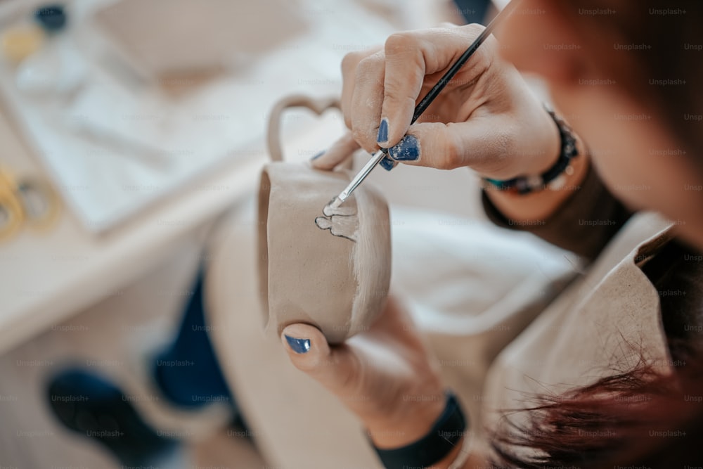 a woman holding a pair of scissors in her hand