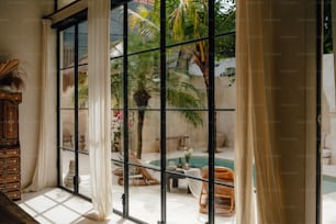 a living room with a pool and a large window