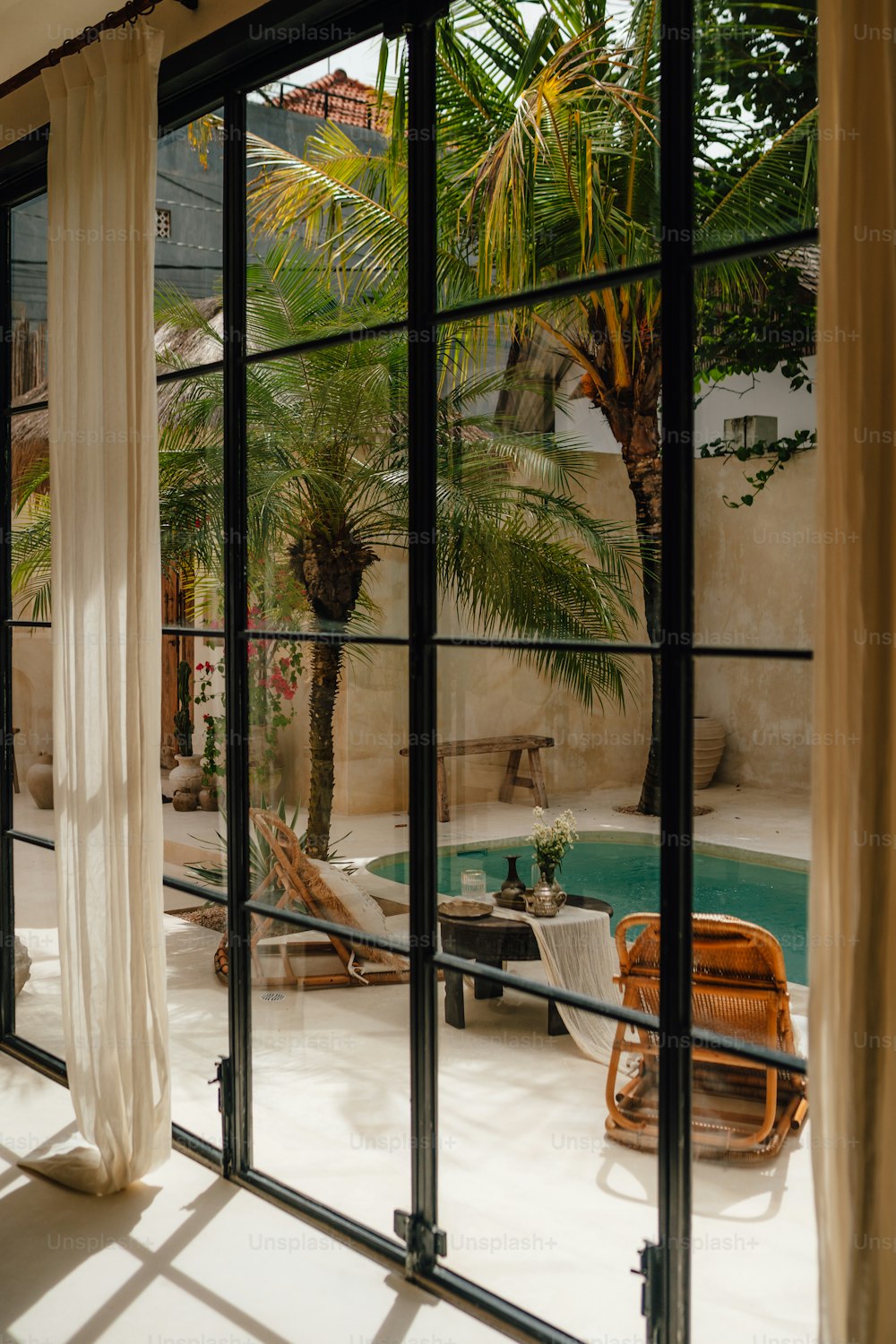 a view of a pool through a glass door