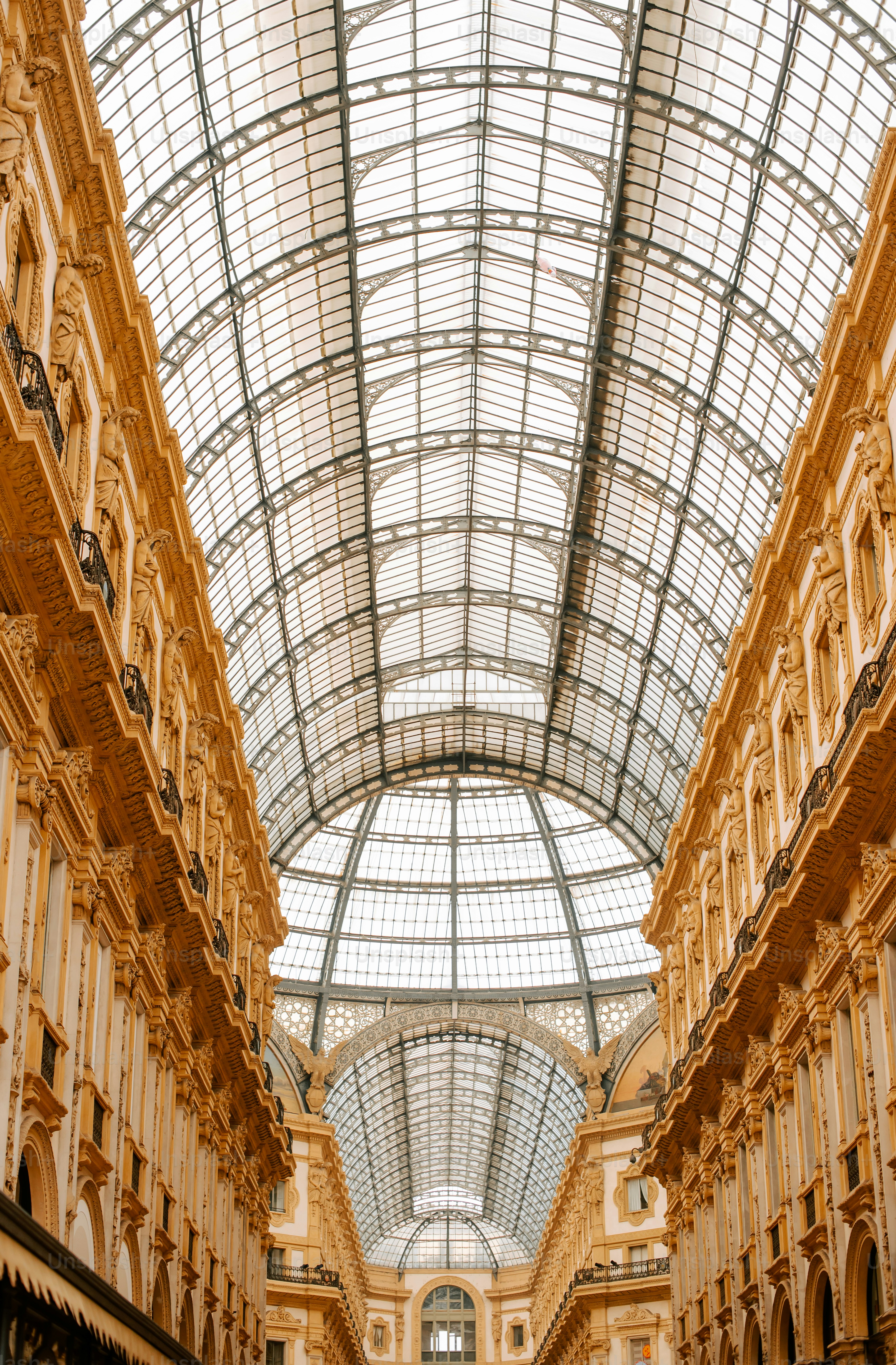 a large building with a glass ceiling and a clock on the wall