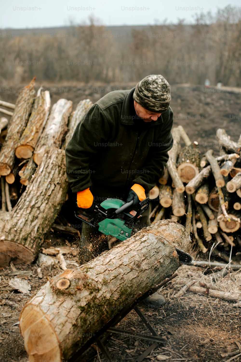 a man with a chainsaw cutting a log