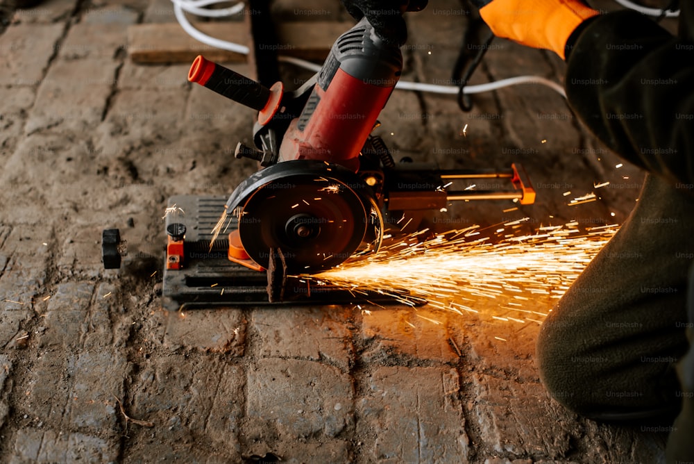 a person using a grinder on a piece of wood