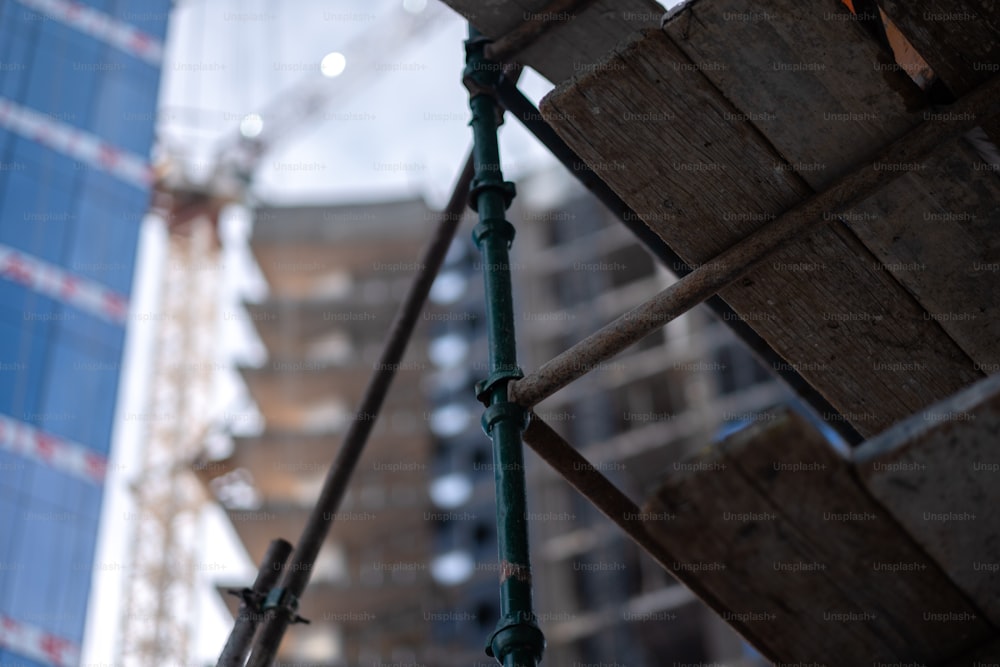 a close up of a fence with a building in the background