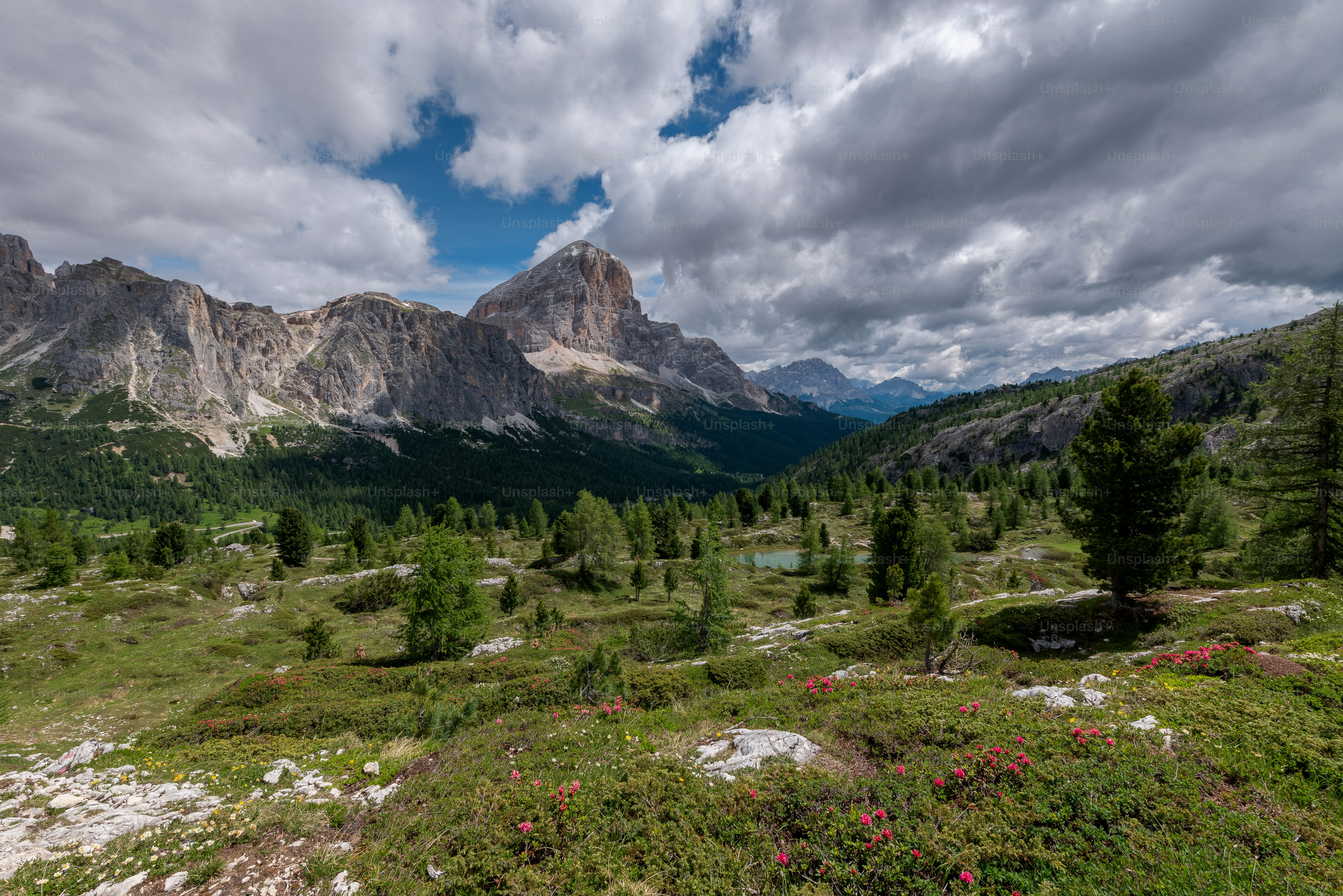 a scenic view of a mountain range with a lake in the foreground