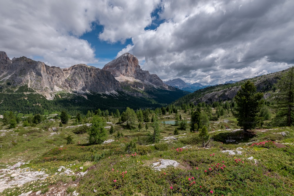 a scenic view of a mountain range with a lake in the foreground